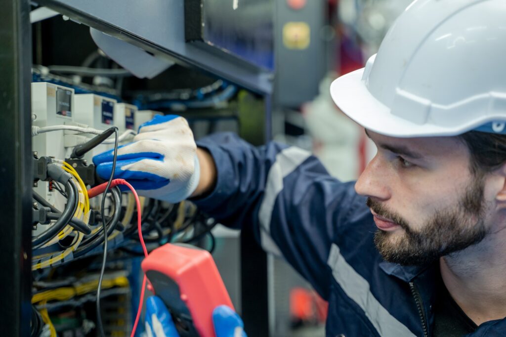 Electrical engineers working to test the voltage and current of the wires.