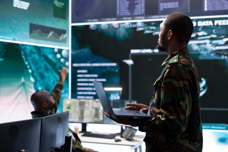 Military staff in high tech command post work on data integration